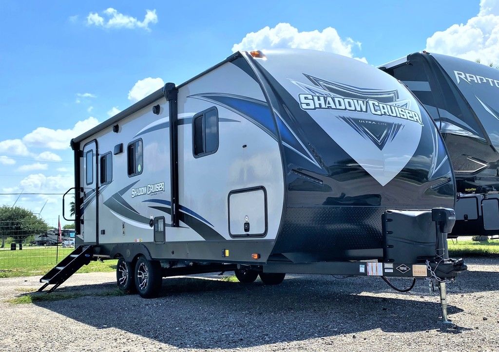 Grey & black striped 2021 Cruiser RV Shadow Cruiser 225RBS travel trailer parked on a lot.